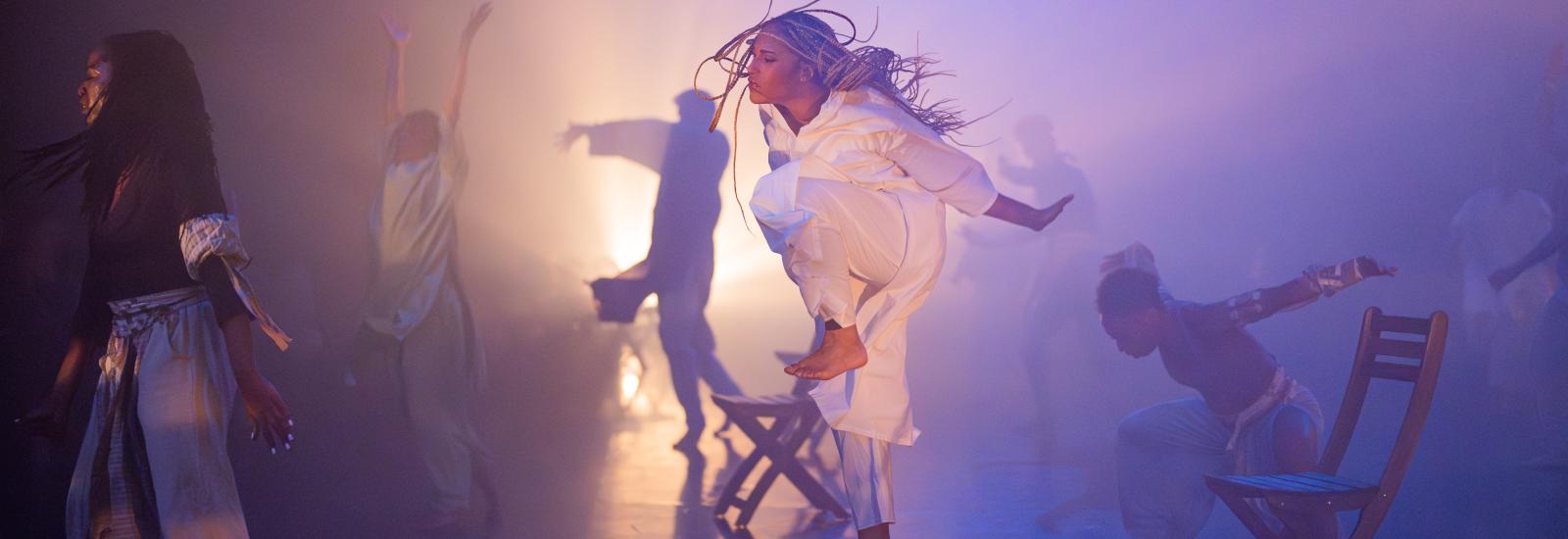 person leaping in white costume